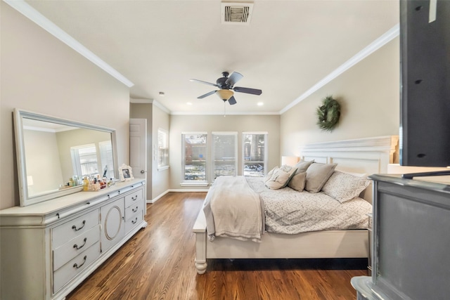 bedroom featuring dark hardwood / wood-style flooring, ornamental molding, and ceiling fan