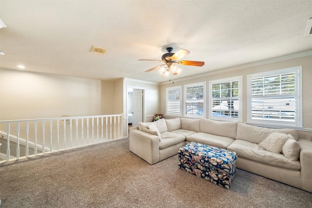 living room featuring crown molding, carpet floors, and ceiling fan