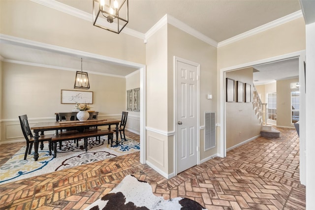 interior space featuring crown molding and a notable chandelier