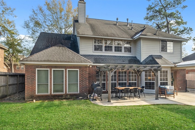 rear view of house with a lawn, a patio area, and a pergola