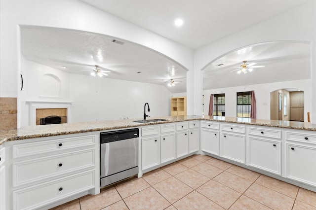 kitchen featuring dishwasher, sink, white cabinets, and ceiling fan