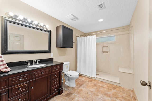 bathroom featuring a shower with curtain, vanity, a textured ceiling, and toilet