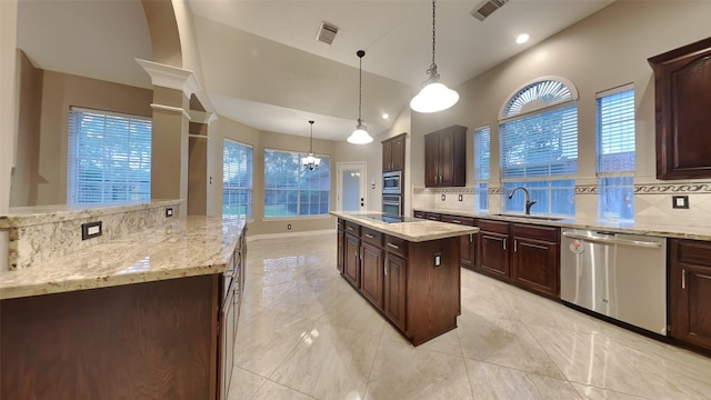 kitchen featuring pendant lighting, dark brown cabinetry, a center island, stainless steel appliances, and sink