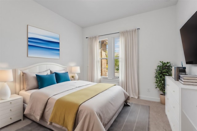 bedroom featuring light colored carpet