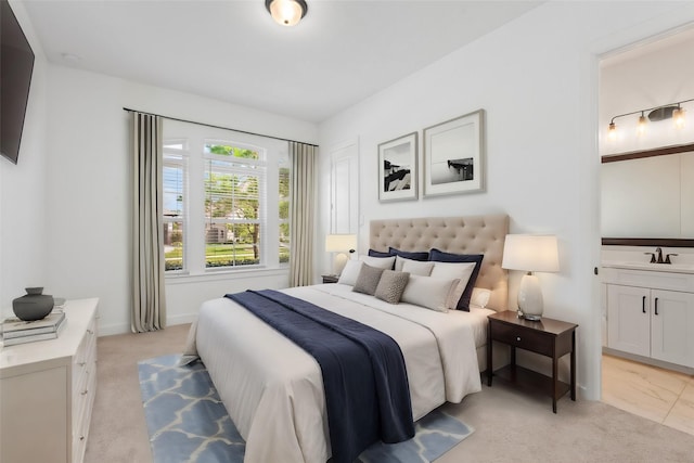 bedroom with sink and light carpet