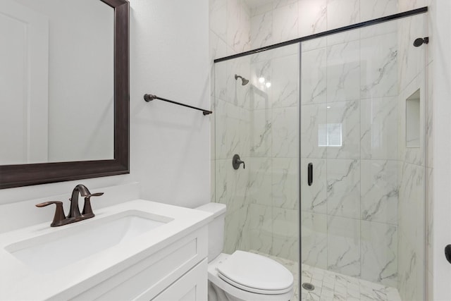 bathroom with vanity, toilet, and walk in shower