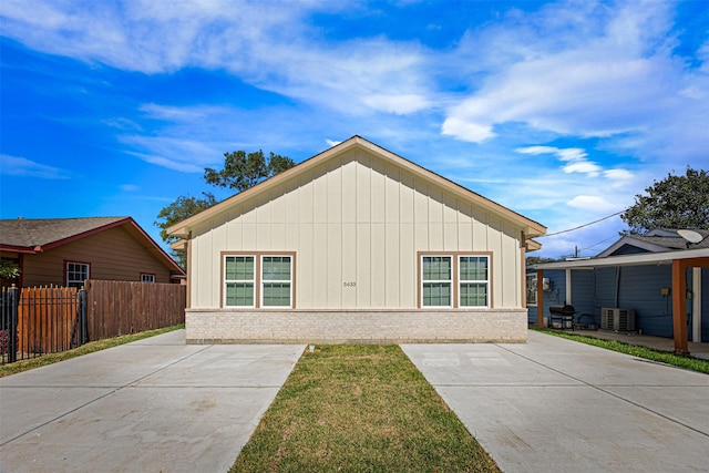 exterior space with central AC and a yard