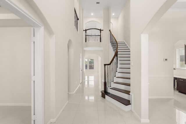 interior space featuring plenty of natural light and a towering ceiling