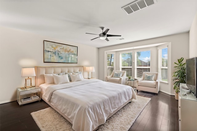 bedroom with ceiling fan and dark hardwood / wood-style flooring