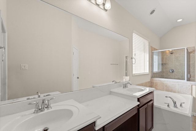 bathroom featuring vanity, lofted ceiling, and separate shower and tub