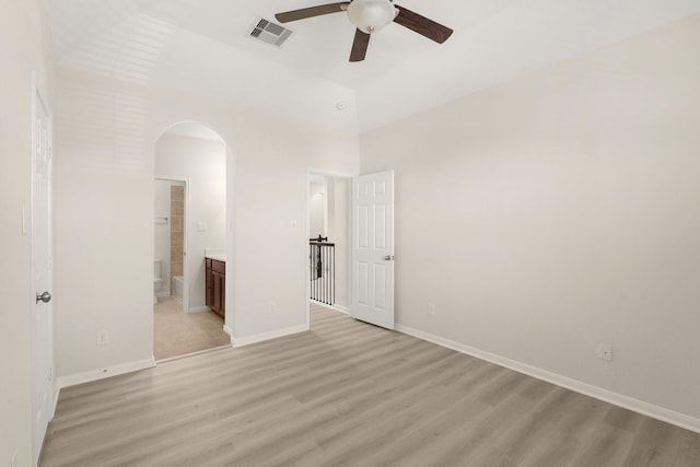 unfurnished bedroom with ceiling fan, light hardwood / wood-style floors, and ensuite bath