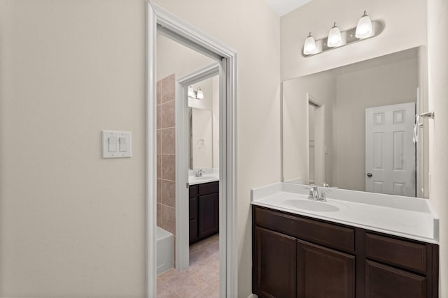 bathroom featuring shower / bathtub combination, vanity, and tile patterned flooring