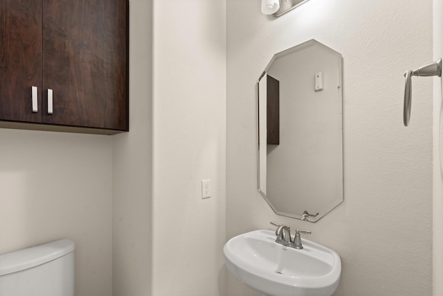 bathroom featuring sink and toilet