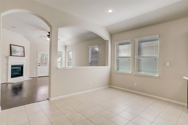 tiled spare room with ceiling fan and lofted ceiling