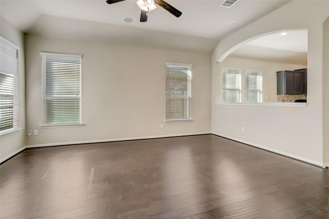 spare room with ceiling fan, lofted ceiling, and dark hardwood / wood-style flooring