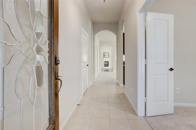 corridor with light tile patterned floors