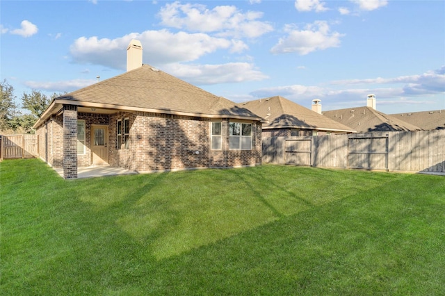 rear view of property with a patio area and a lawn