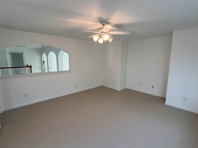 6731 Pinetop Glen Ln, Spring, TX 77379 - spare room featuring a ceiling fan, carpet, baseboards, and arched walkways