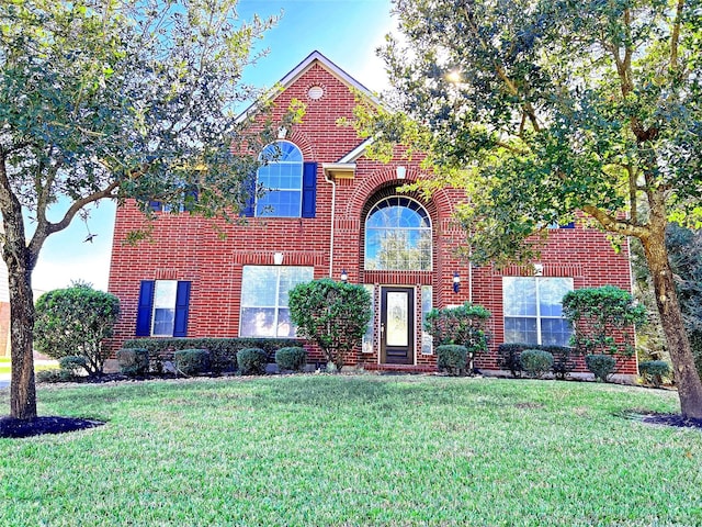 6731 Pinetop Glen Ln, Spring, TX 77379 - traditional home featuring brick siding and a front lawn