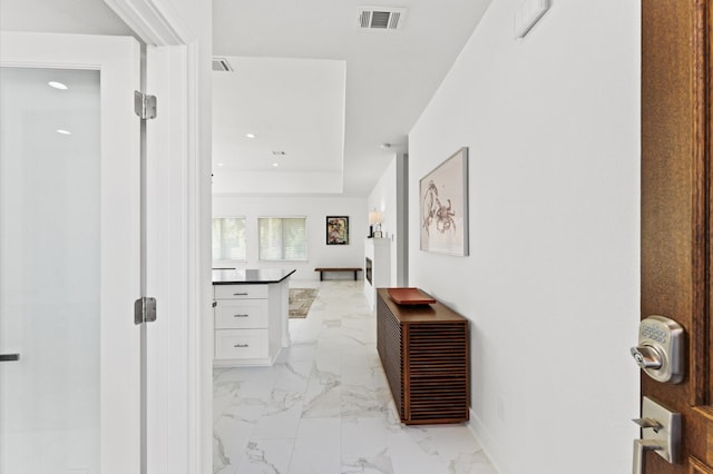 corridor featuring a tray ceiling