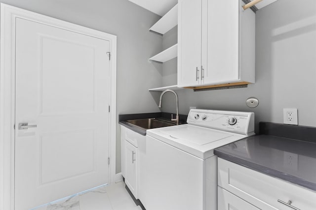 laundry area with sink, washer / dryer, light tile patterned floors, and cabinets