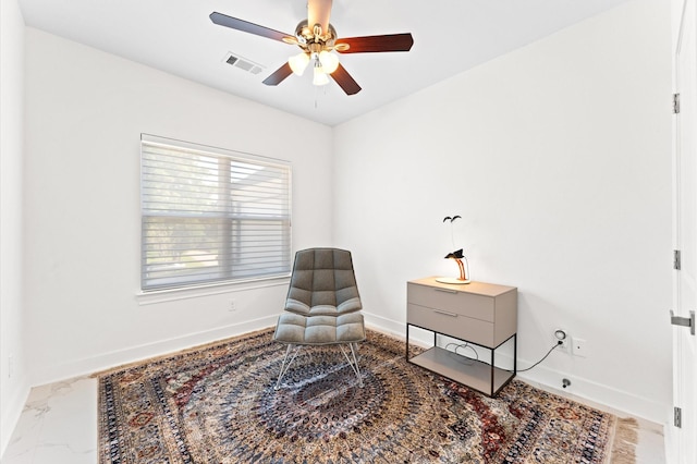 sitting room featuring ceiling fan