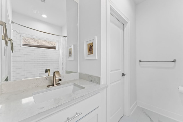 bathroom with walk in shower and vanity