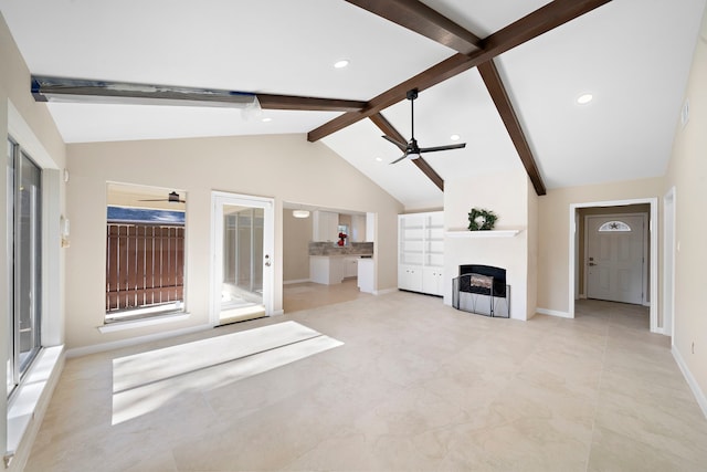 unfurnished living room with ceiling fan and lofted ceiling with beams