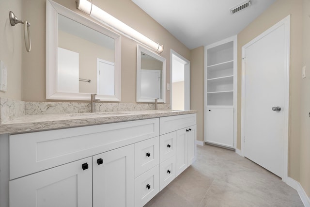 bathroom featuring vanity and built in features