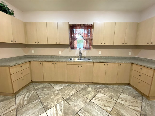 kitchen featuring sink and light brown cabinetry