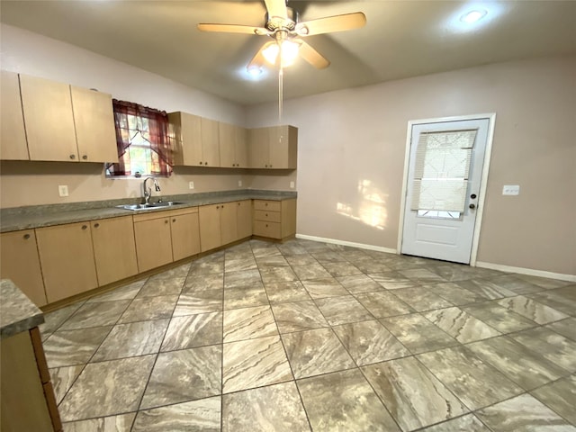 kitchen with sink, ceiling fan, and light brown cabinetry