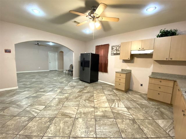 kitchen with ceiling fan, light brown cabinetry, and stainless steel refrigerator with ice dispenser