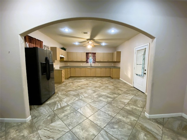 kitchen featuring sink, stainless steel fridge with ice dispenser, light brown cabinetry, and ceiling fan