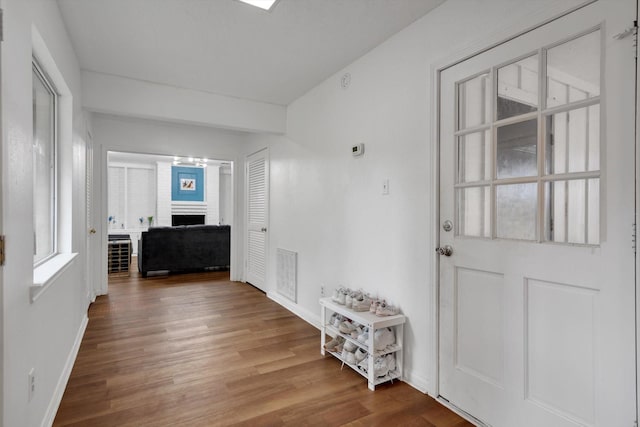 corridor with hardwood / wood-style floors