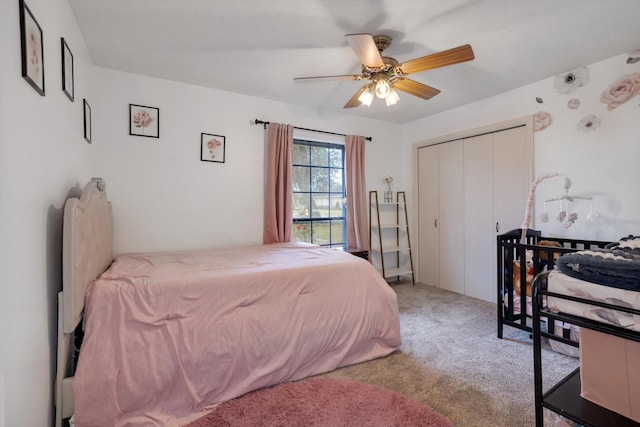 bedroom with light colored carpet, a closet, and ceiling fan