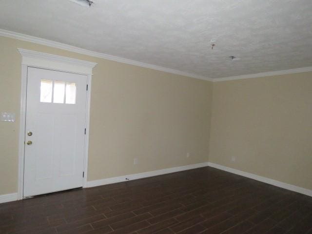 foyer entrance with dark wood-type flooring and crown molding