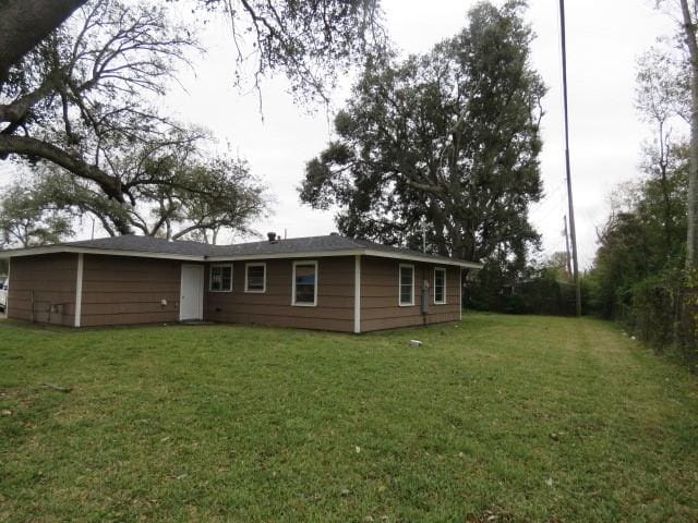 back of property featuring a lawn