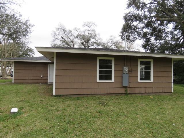 rear view of property featuring a yard