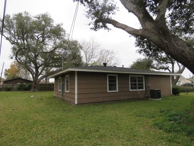 view of home's exterior featuring central AC and a yard