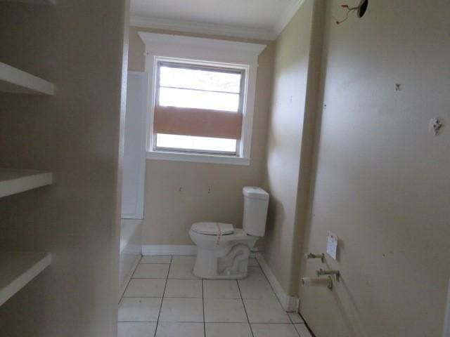 bathroom featuring toilet, tile patterned floors, and crown molding