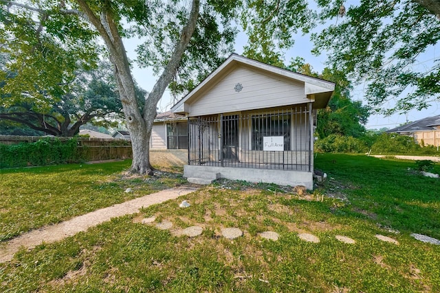 bungalow-style house with a front yard