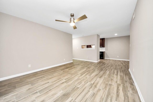 unfurnished living room with ceiling fan and light hardwood / wood-style floors