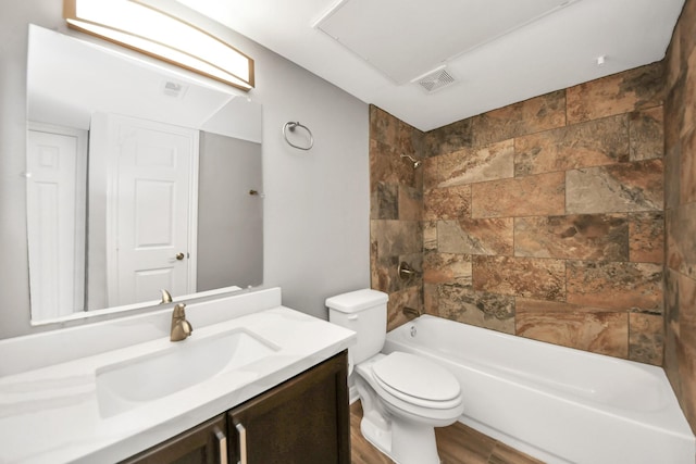 full bathroom featuring vanity, toilet, tiled shower / bath, and hardwood / wood-style flooring