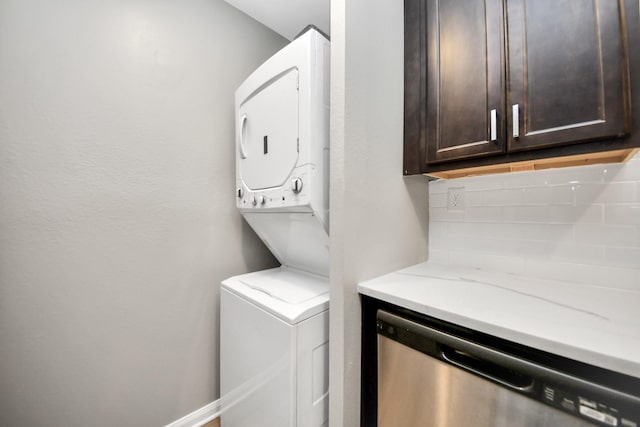 laundry area with stacked washer and clothes dryer