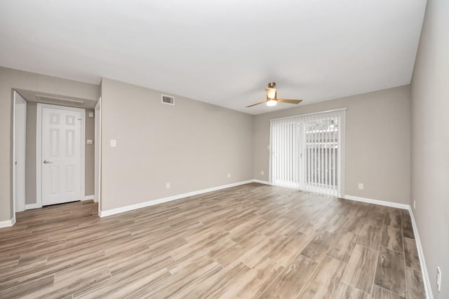 empty room with light wood-type flooring and ceiling fan