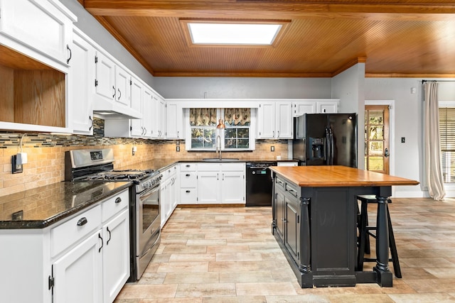 kitchen with black appliances, a center island, wood ceiling, white cabinetry, and sink