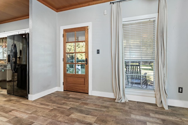 doorway with hardwood / wood-style flooring, crown molding, and wood ceiling