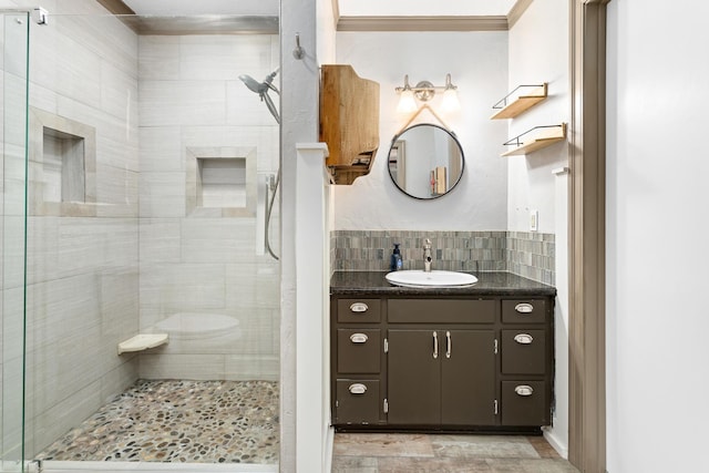 bathroom featuring vanity, walk in shower, and decorative backsplash