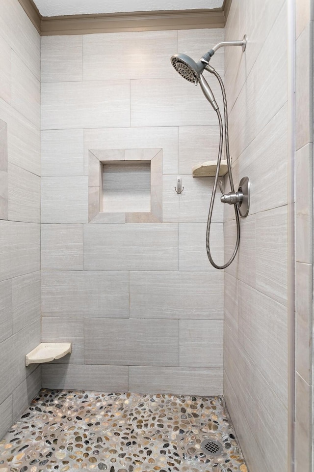 bathroom with tiled shower