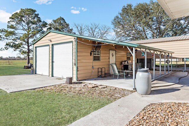 garage featuring a yard and a carport